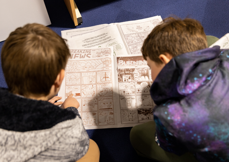 Artist in Residence Night, Image of two children reading a comic