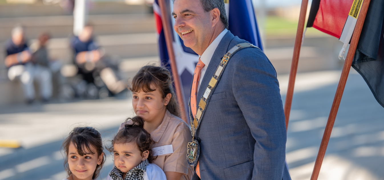 Mayor Mark Irwin and family members of a new citizen