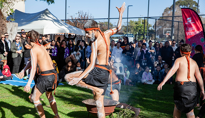 Aboriginal dancers perform in front of a crowd at NAIDOC Mirrabooka.