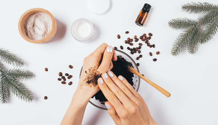 A coffee scrub is applied to a hand.