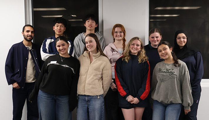 Group of young people standing together for a photo during a youth leadership or community program event.