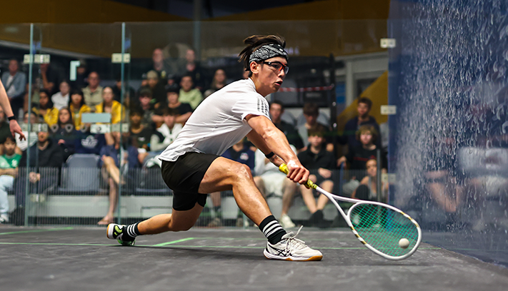 Arthur Law lunges for a squash ball.