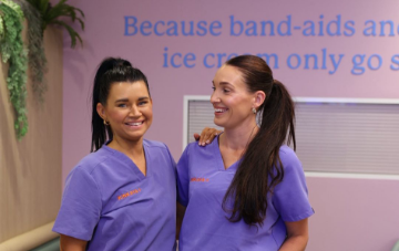 Two medical professionals laughing and smiling.