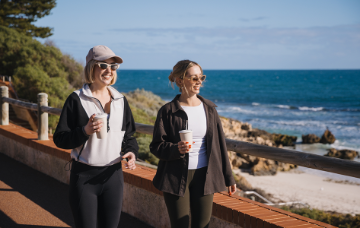 Two women walking along the coast north of Scarborough