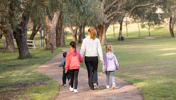 A family walking on a path in a park.