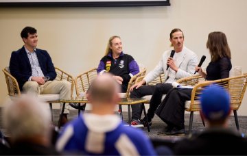 A group of WA sporting leaders speak at a function.