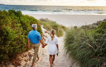 A couple holding hands on the beach