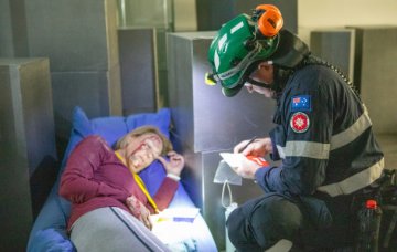 A paramedic speaks to a 'casualty'.