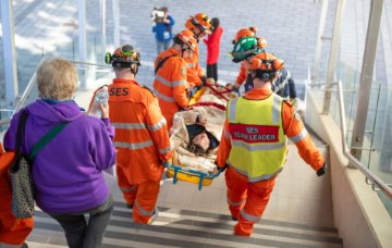 SES volunteers carry a 'casualty' to safety.