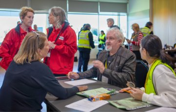Staff speak to a local at the mock evacuation centre.