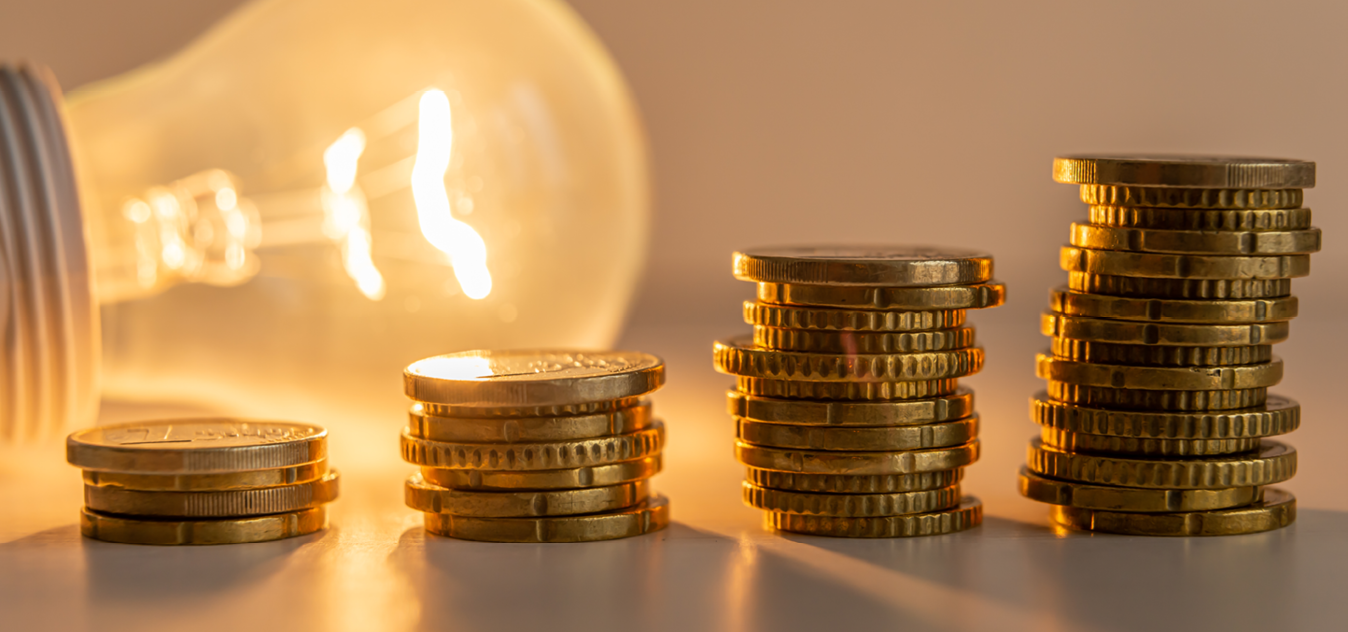 A stack of coins and a light bulb